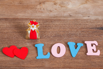 color love letters on wood with flower basket