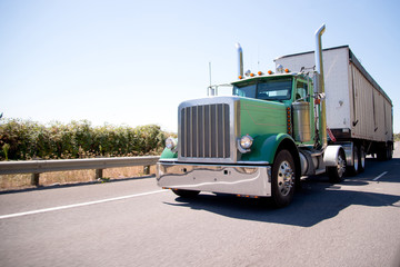 Big rig attractive green semi truck with bulk trailer © vit