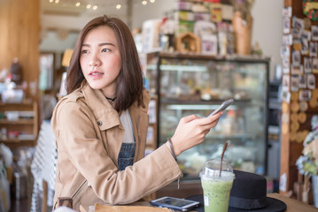 Cute asian girl type text on smartphone in hand ,Social network in hand ,Online business on mobile