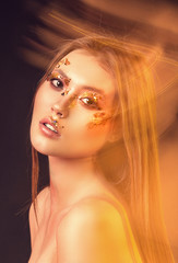 Portrait of a girl, model with beautiful, creative make-up in the studio with color filters. Beauty, portrait, style, fashion, make-up, filters.