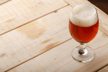 Red ale on light wood