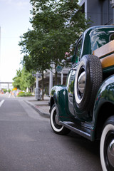 Green retro truck on city street