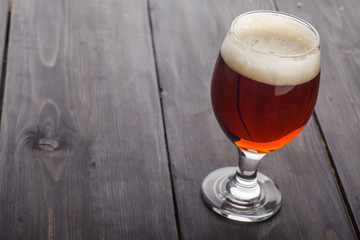 Red ale on dark wood