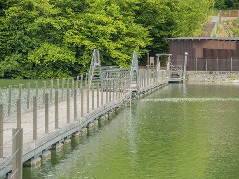 floating wooden bridge over the lake with free pasage for boats
