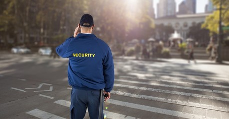 Obraz premium Rear view of security guard standing on road in city