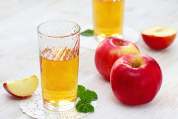 Apple juice and apples on the table