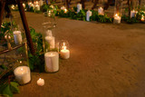 many candles in glass vases on the floor on hipster style wedding ceremony