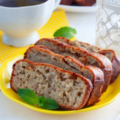Banana cake on a yellow plate, square
