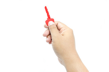Man's hand holds a red key, isolated on a white background
