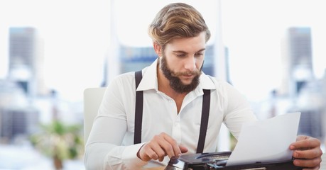 Fototapeta premium Creative businessman working on laptop in office