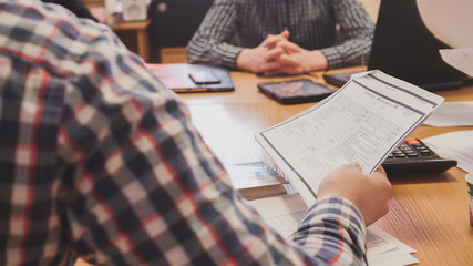 Business people in meeting room discussing financial report using data and gadget