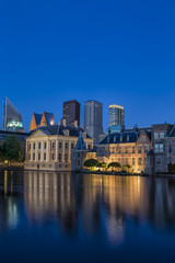 Fototapeta na wymiar Binnenhof Palace of Parliament inThe Hague in The Netherlands Shot During Blue Hour Time. Against Modern Skyscrapers on Background.