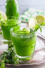 Homemade lemonade from fresh tarthun with lime in glass glasses, selective focus