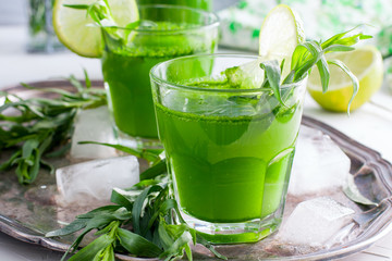 Two glass glasses with a drink from the leaves of the tarragon, horizontal