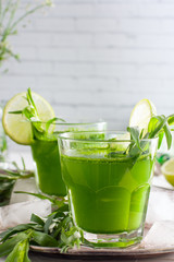 Homemade lemonade from fresh tarthun with lime in glass glasses, selective focus