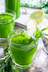 Homemade lemonade from fresh tarthun with lime in glass glasses, selective focus