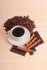 Coffee cup and chocolate on wood table