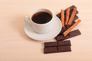 Coffee cup and chocolate on wood table