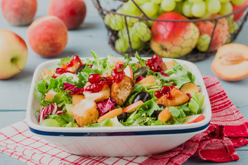 French salad with baked camembert, cranberries and fresh fruit.