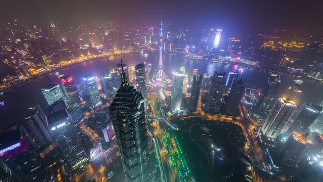 Shanghai at night, time lapse. Aerial view of high-rise buildings with Huangpu River in Shanghai, China. 