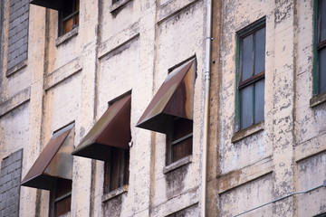 Wall of the old industrial building with windows and air ducts