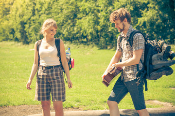 Hiking young couple with guitar backpack outdoor
