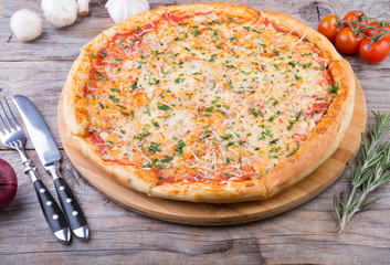 Whole baked pizza on a board