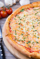 Whole baked pizza on a board