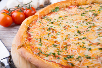 Whole baked pizza on a board