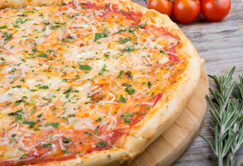 Whole baked pizza on a board