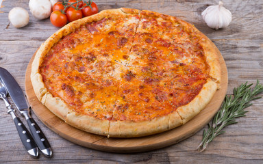 Whole baked pizza on a board