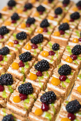 Buffet cake with blackberry. Many pieces