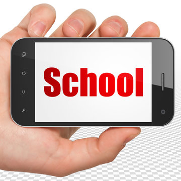 Learning concept: Hand Holding Smartphone with School on display
