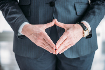 Obraz premium Close-up partial view of hands of senior businesswoman in formal wear