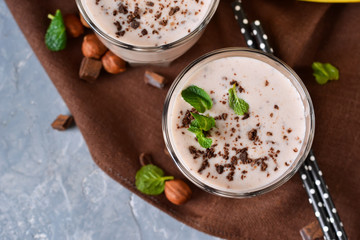 Vanilla, Banana smoothie with cookies and chocolate on a concrete background