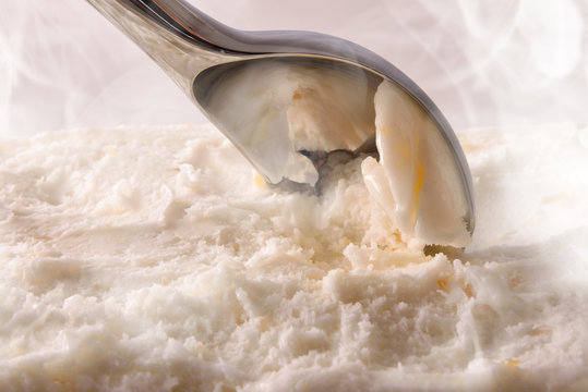 Making vanilla ice cream with scoop close up elevated
