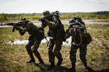 A group of special forces in a field with weapons