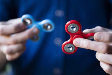 A person holding popular fidget spinner toy