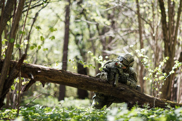 Scout with weapons in forest