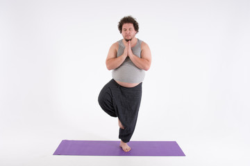 Funny fat man and yoga. Sport, diet and a healthy lifestyle.  