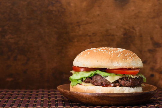 Tasty burger on a wooden background copyspace