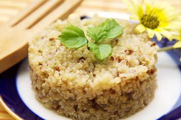 Whole spring quinoa dish with wooden cutlery
