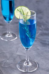 blue curacao cocktail with rosemary, lime and lemon