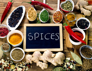 Colorful spices on wooden board.