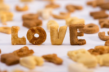Close-up view of word love and healthy breakfast cereal alphabet isolated on grey