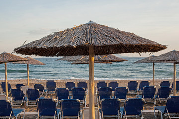 Beach chairs and umbrellas on the beach.