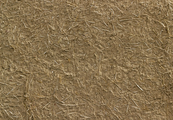 Old clay wall cracked straw background