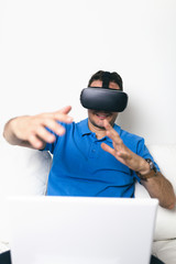 Young man using virtual reality headset or glasses. 