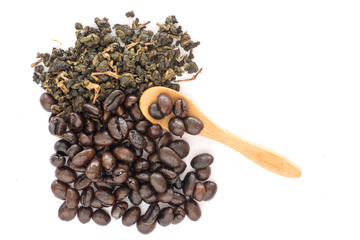 Coffee bean and tea leaves top view with wooden spoon on white background