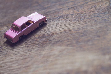 closeup of vintage toy pink car